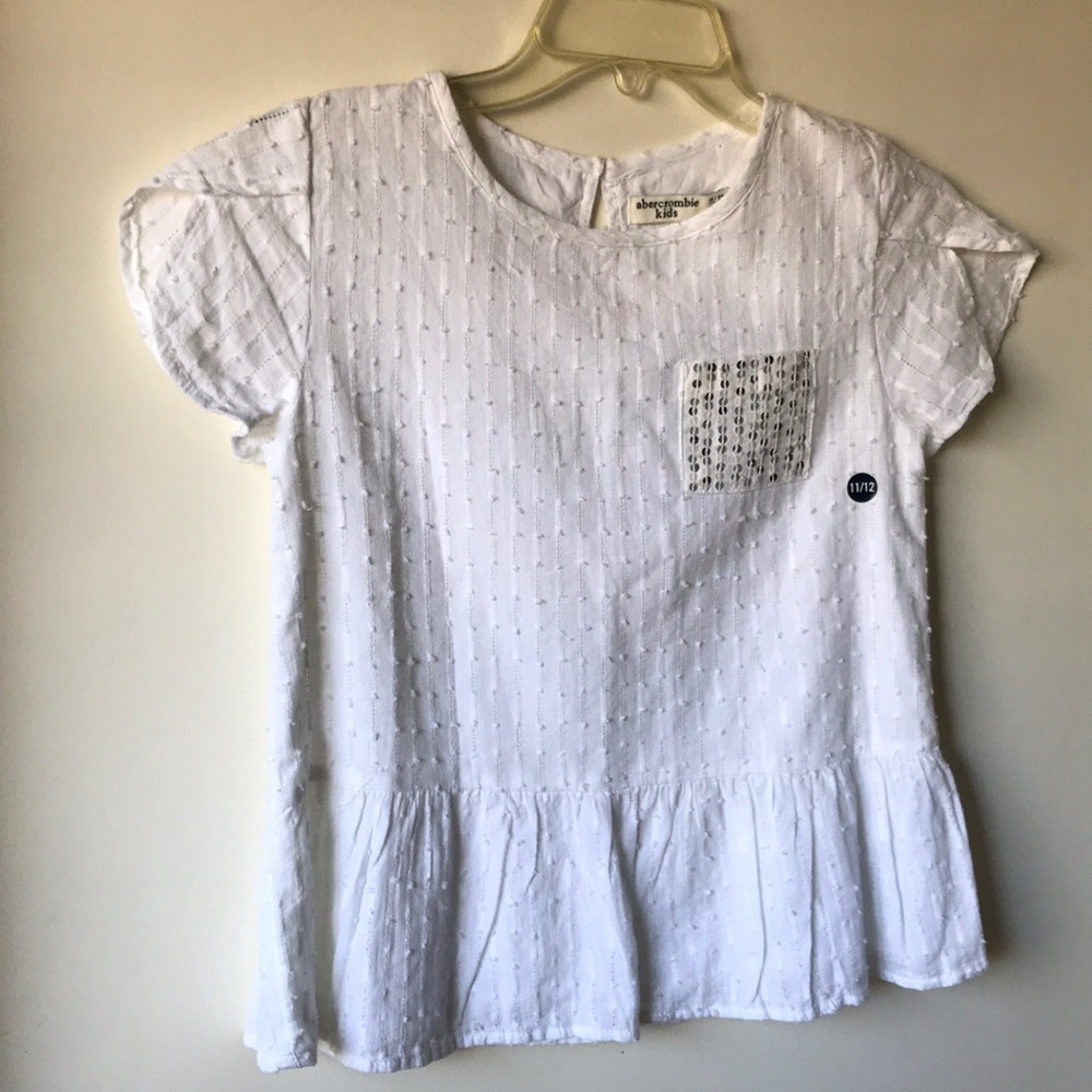 White top with silver sequence pocket accent.